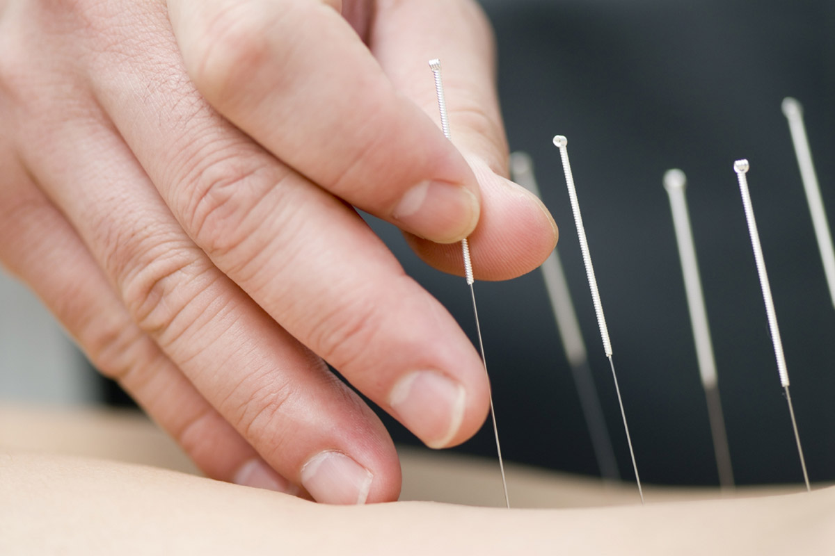A woman in a chair receiving Pulsed Electromagnetic Field Therapy